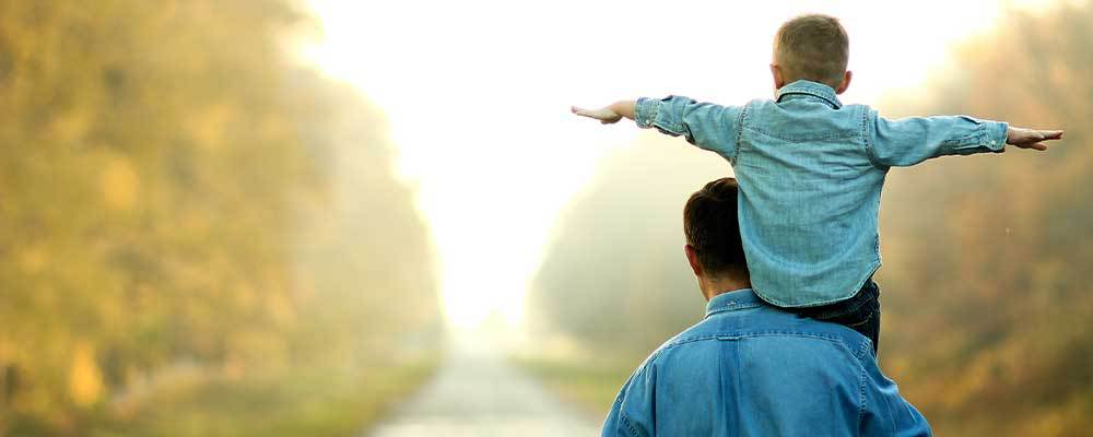 Young child on fathers shoulders 